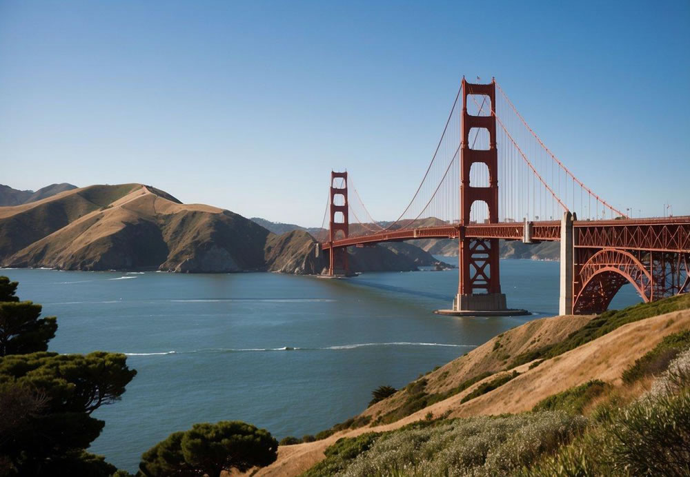 The iconic Golden Gate Bridge stands tall against a backdrop of blue skies and rolling hills, with the shimmering waters of the bay below